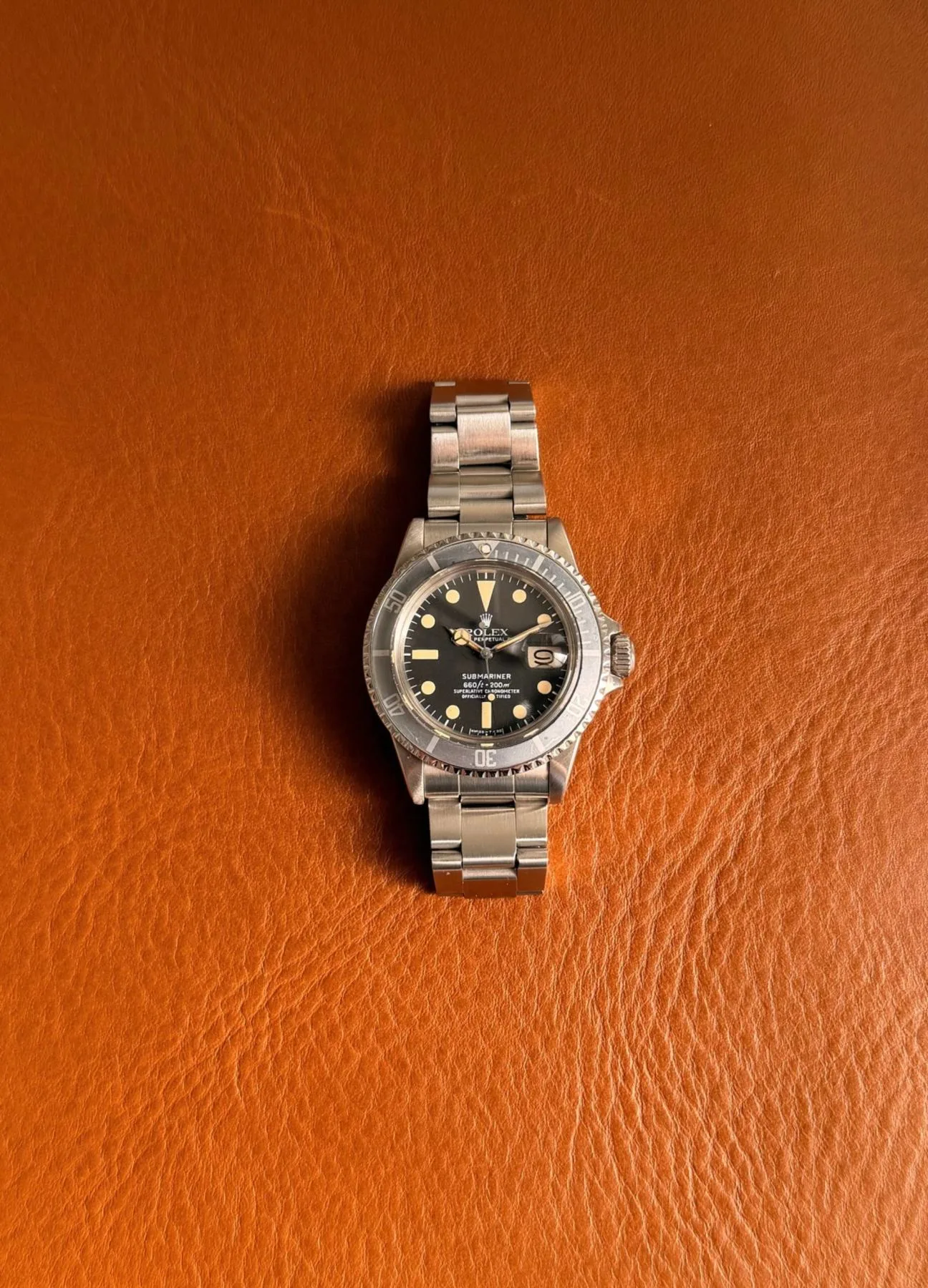Rolex Submariner Date “White Ghost” visto de frente, por inteiro, sobre couro